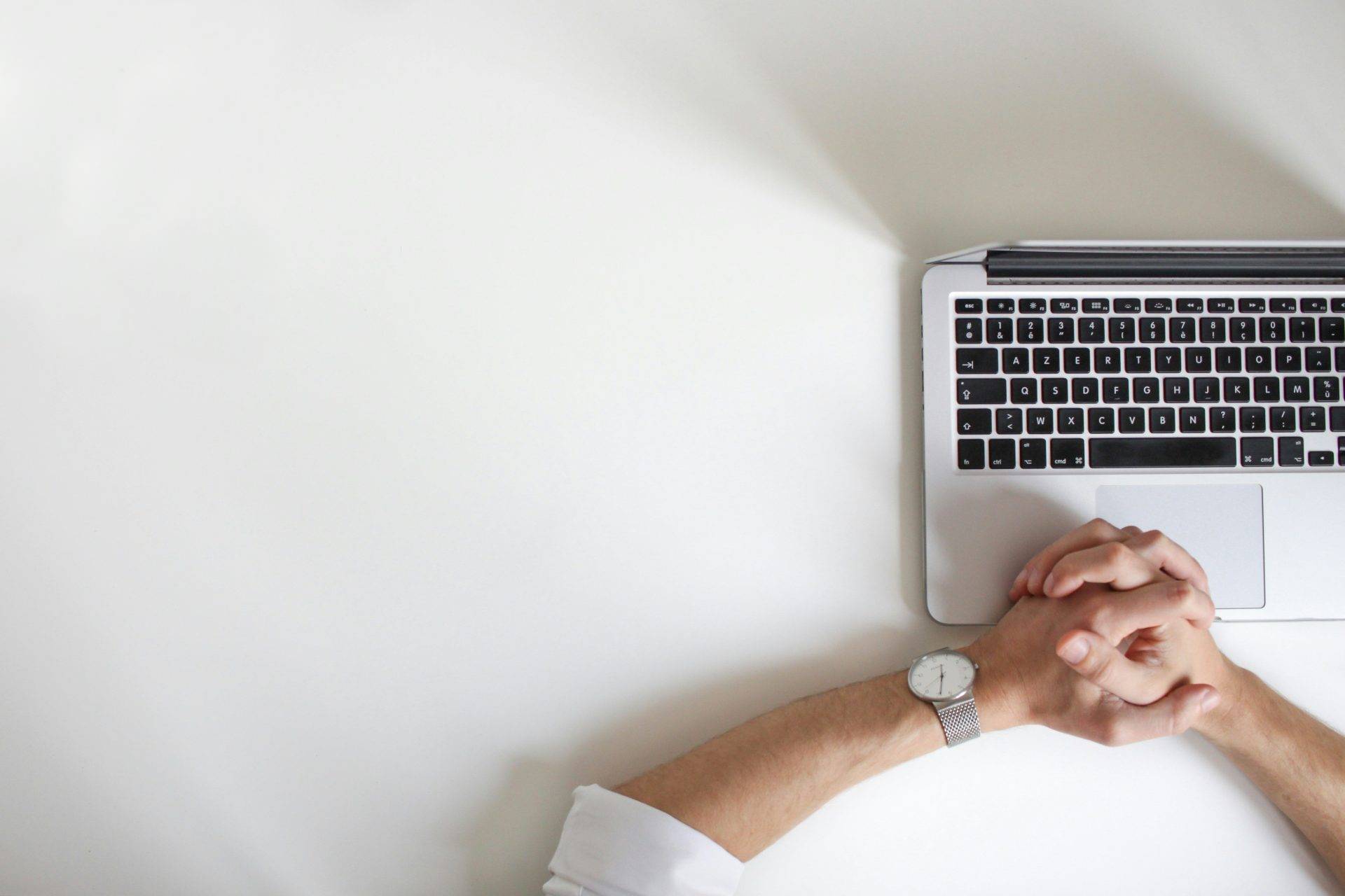 person wearing watch near laptop